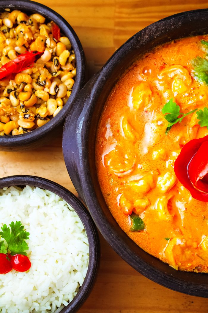 who-we-are Vibrant Indian curry dish served with rice and beans, perfect for a hearty meal.